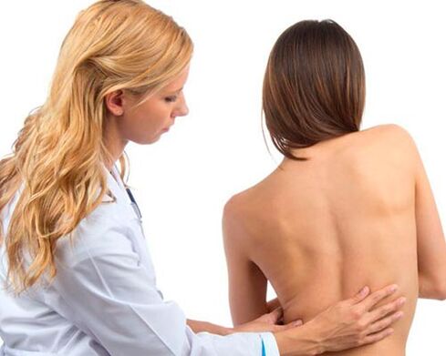 doctor examining back for lower back pain